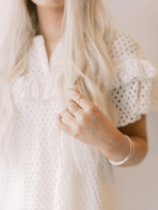 girl white dress hands rings bracelets